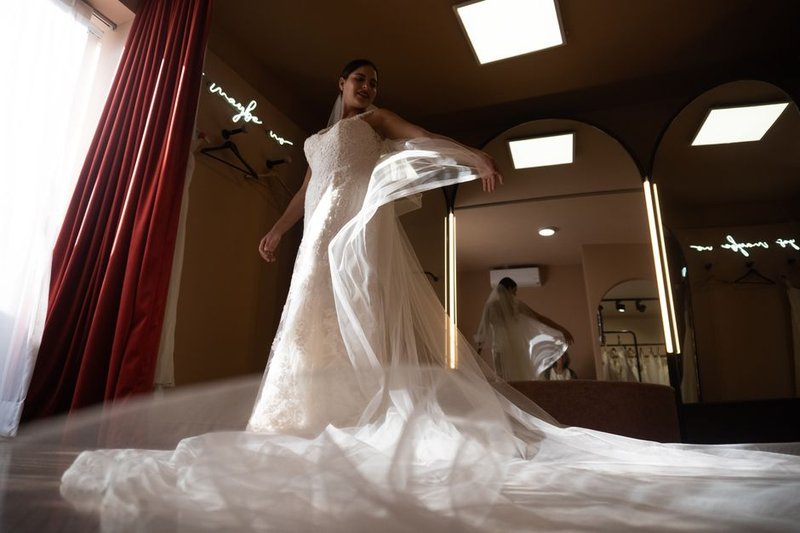 Bridal alteration specialist fitting a wedding dress